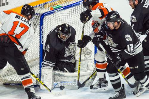 Chris Detrick  |  The Salt Lake Tribune
Grizzlies' Mark Owuya (1) makes a save as Komets' Alex Belzile (17) and Komets' Kyle Thomas (24) attempt to score during Game 4 of the ECHL playoff series at Maverik Center Friday May 6, 2016.