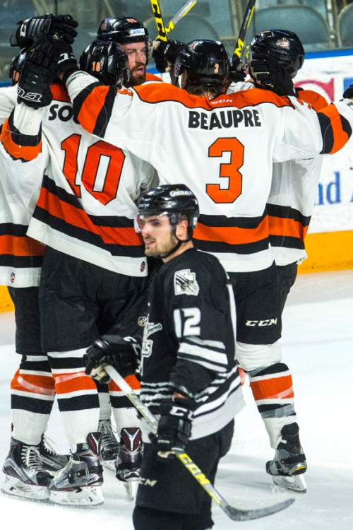 Chris Detrick  |  The Salt Lake Tribune
Komets' Garrett Thompson (48) celebrates with his teammates as Grizzlies' Marc Cantin (12) skates by during Game 4 of the ECHL playoff series at Maverik Center Friday May 6, 2016.