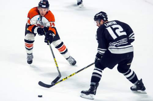 Chris Detrick  |  The Salt Lake Tribune
Komets' Troy Bourke (14) and Grizzlies' Marc Cantin (12) during Game 4 of the ECHL playoff series at Maverik Center Friday May 6, 2016.