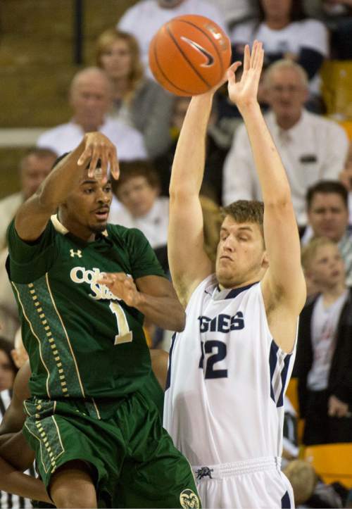 Rick Egan  |  The Salt Lake Tribune

Utah State Aggies forward Lew Evans (12) defends as Colorado State Rams guard Antwan Scott (1) tosses a pass, in college basketball action, Utah State Aggies vs. The Colorado State Rams, at the Dee Glen Smith Spectrum in Logan,  Wednesday, February 17, 2016.