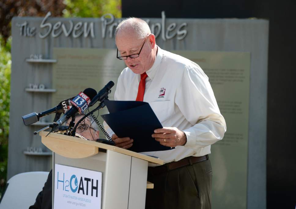 Francisco Kjolseth | The Salt Lake Tribune 
Gathered at the Conservation Garden Park at Jordan Valley, Mike Styler, director of department of natural resources reads the "H2Oath: Utah's Water-wise Pledge" to encourage additional water conservation efforts by families, businesses, government agencies and statewide organizations. The H2Oath was designed to commit individuals and groups to conserve more by following the division's Weekly Lawn Watering Guide throughout the watering season, and making several other water conservation commitments.