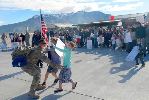 Al Hartmann  |  The Salt Lake Tribune
Families greet members of the 421st F-16 fighter squadron Tuesday May 10 at Hill Air Force Base.  Some 300 maintenance and support personnel arrived home after an eight month assignment in Afghanistan.