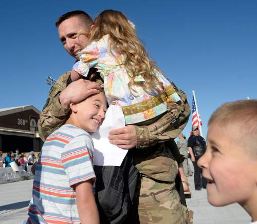 Al Hartmann  |  The Salt Lake Tribune
Master Sgt. Christopher Aguilar of Hill Air Force Base's 421st F-16 fighter squadron has his arms full with his children arriving home Tuesday, May 10 after an eight month assignment in Afghanistan.