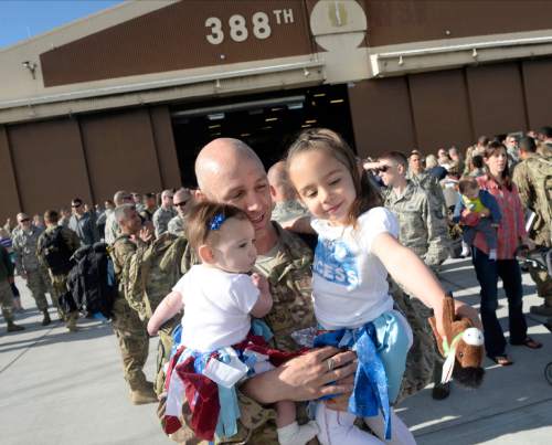 Al Hartmann  |  The Salt Lake Tribune
Tech. Sgt. William Cronin of the 421st F-16 fighter squadron gives his daughter Leah a hug and meets his 5-month old daughter Amanda for the first time Tuesday May 10 at Hill Air Force Base.  Some 300 maintenance and support personnel arrived home after an eight month assignment in Afghanistan.