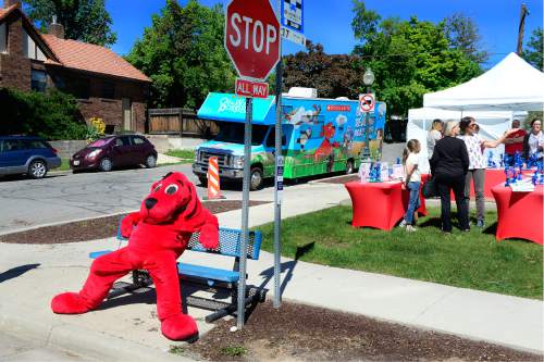 Scott Sommerdorf   |  The Salt Lake Tribune  
"Clifford the Big Red Dog" takes a break on a bus bench after entertaining children at the Scholastic "Summer Reading Road Trip" pop-up book festival at the King's English Bookshop in Salt Lake City, Wednesday, May 11, 2016. Kids and families had the opportunity to participate in their very own "pop-up" reading festival, and meet some of their favorite authors and illustrators, and engage in fun reading activities.