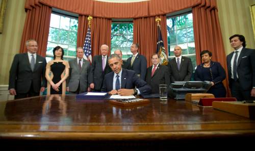 President Barack Obama signs the Defend Trade Secrets Act of 2016 (DTSA), in the Oval Office of the White House in Washington, Wednesday, May 11, 2016. The Act would establish a Federal civil private cause of action for trade secret theft that would provide businesses with a more uniform, reliable, and predictable way to protect their valuable trade secrets anywhere in the country. Standing behind Obama are from left are,  Deputy U.S. Trade Representative Ambassador Robert W. Holleyman, Commerce Undersecretary Michelle Lee, Rep. Bob Goodlatte, R-Va., Sen. Orrin Hatch, R-Utah, Sen. Chris Coons, D-Del., Rep. Doug Collins, R-Ga., Rep. Jerrold Nadler, D-NY., Rep. Hakeem Jeffries, D-NY., Attorney General Loretta Lynch, and U.S. Intellectual Property Enforcement Coordinator Danny Marti. (AP Photo/Pablo Martinez Monsivais)