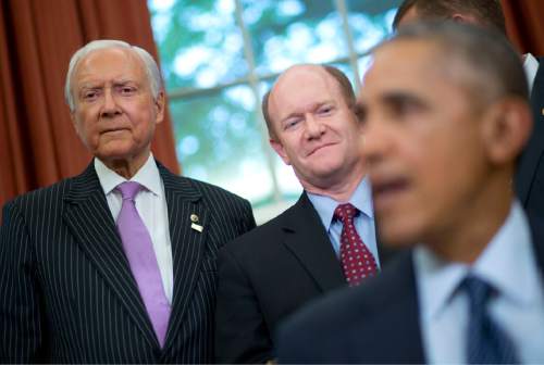 Sen. Orrin Hatch, R-Utah, left, and Sen. Chris Coons, D-Del., center, listen as President Barack Obama speaks in the Oval Office of the White House in Washington, Wednesday, May 11, 2016, before signing the Defend Trade Secrets Act of 2016 (DTSA). Coons and Hatch cosponsored the bill that would establish a Federal civil private cause of action for trade secret theft that would provide businesses with a more uniform, reliable, and predictable way to protect their valuable trade secrets anywhere in the country. (AP Photo/Pablo Martinez Monsivais)