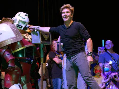 Leah Hogsten  |  The Salt Lake Tribune
Voice actor Vic Mignogna shares the mic with Space Marine Jon Robinson of West Valley during his into and sing along to Journey's  "Don't Stop Believin" at the second annual Comic Con, Sept. 4-6, at the Salt Palace Convention Center, Sept. 4, 2014. Mignogna will return to Salt Lake Comic Con for its 2016 run Sept. 1-3.