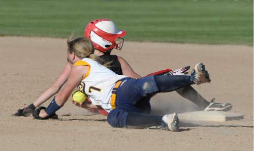 Francisco Kjolseth | The Salt Lake Tribune 
Lacy Drake of Enterprise just misses an out of Kamree Peterson of South Sevier at second base in the Class 2A softball second round in Spanish Fork on Thursday, May 12, 2016. Enterprise advance with a final score of 7-6.