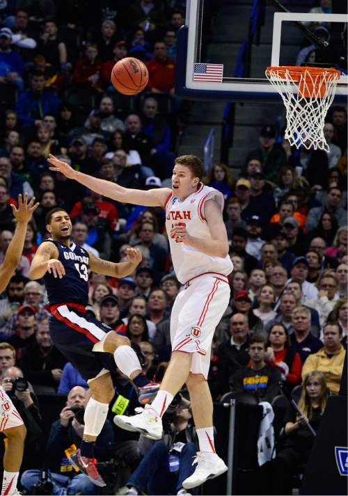 Scott Sommerdorf   |  The Salt Lake Tribune  
Utah F Jakob Poeltl (42) redirects a pass by Gonzaga G Josh Perkins (13) during second half play. Gonzaga beat Utah 82-59 in Denver, Saturday, March 19, 2016.