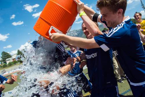 Chris Detrick  |  The Salt Lake Tribune
Waterford's Patrick Dowd (27) and Sean Keough (17) pour ice water on head coach George Shirley after winning the 3A championship game at Alta High School Saturday May 14, 2016. Waterford defeated Wasatch Academy 6-0.