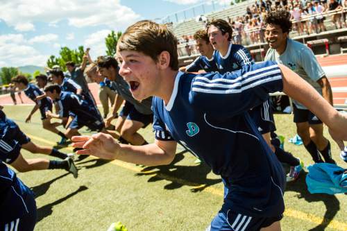 Chris Detrick  |  The Salt Lake Tribune
Juan Diego's Matt Lilien (5) and other members of the soccer team celebrate after winning the 3A championship game at Alta High School Saturday May 14, 2016. Juan Diego defeating Snow Canyon 1-0.