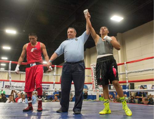 Rick Egan  |  The Salt Lake Tribune

Frankie Gould, Idaho (red) fights Bladimir Estrada, Utah (blue) in the152 weight class, in the Golden Gloves Boxing Rocky Mountain Regionals, at the South Towne Expo Center in Sandy, Saturday, April 30, 2016. Estrada won the match.