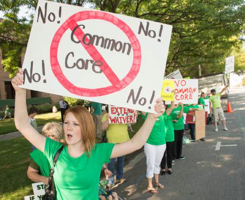 Rick Egan  |  The Salt Lake Tribune

Holly Jorgensen, Roy, chants with a group of protestors against common core hold signs outside the the Utah Office of Education, Friday, August 8, 2014