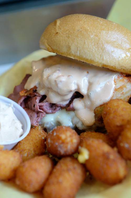 Francisco Kjolseth | The Salt Lake Tribune 
The Silly Round Eye featuring beef patty, Swiss, pastrami, kimchi and fry sauce with Chedda tots.Chedda Burger owner Nick Watts started his business as a food truck but was so successful he recently added a stand-alone restaurant at 26 E. 600 South in Salt Lake City.