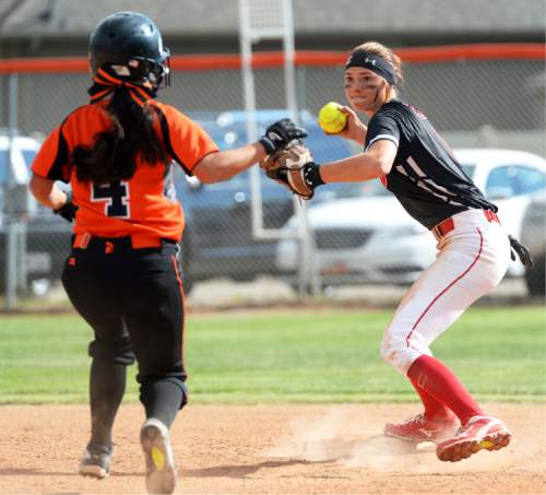 Steve Griffin / The Salt Lake Tribune

Uintah's Brinlee Barker tags second and forces out Murray Madison Kaneko in the first round of the Class 4A softball tournament in Murray Tuesday May 17, 2016.