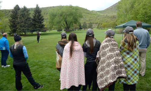 Al Hartmann  |  The Salt Lake Tribune
Crowd wrapped in blankets for stormy weather watch the final threesome tee off  on the final day of the of the 5A girls' golf tournament on the Lake Course at Wasatch Mountain State Park Monday May 17.