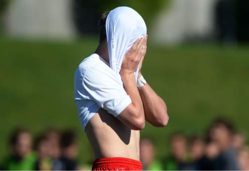 Steve Griffin / The Salt Lake Tribune

Ala celebrates their victory as East's Erik Hulbert holds his shirt covered head as he walks off the field after Alta defeated the Leopards 1-0 in the first-round of the 4A boys' soccer tournament game at East High School in Salt Lake City Wednesday May 18, 2016.