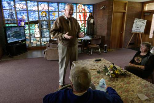 FILE -- In this Monday, May 16, 2016 file photo Jon Rogers, top, a spokesman for Friends of St. Frances Cabrini, speaks with parishioners at St. Frances X. Cabrini church, in Scituate, Mass. Now that the U.S. Supreme Court has refused to hear their last-ditch appeal, parishioners who have occupied the Roman Catholic church for 11 years in defiance of the Boston archdiocese's order to close it are vowing to create an independent church outside the Vatican's control. (AP Photo/Steven Senne, File)