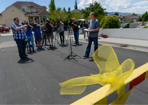 Francisco Kjolseth | The Salt Lake Tribune
Yellow ribbons adorn the neighborhood as Richard Massey, a family spokesperson for missing UTA worker 63-year-old Kay Porter Ricks, whose body was found Tuesday in Wyoming, speaks with the media outside their neighborhood ward in American Fork on Wednesday, May 18, 2016.