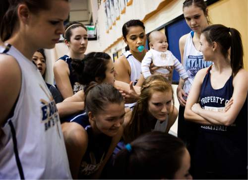 Kim Raff  |  Tribune file photo

Skyline High School basketball player Ta'a Tuinei (center) holds her infant son, Tereinga, during a team meeting in 2012. This photo, by then-Salt Lake Tribune photographer Kim Raff, is one of the images included in "Through Her Eyes: Photography by Utah Female Journalists," an exhibit opening May 16, 2016, at the Salt Lake City Library's main branch.