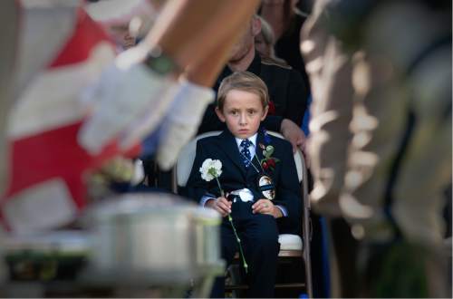Leah Hogsten  |  Tribune file photo

Ben Johnson, then 6 years old, watched Draper police officers fold the flag draped over the casket of his father, Sg. Derek Johnson, who was killed in the line of duty in 2013. This photo, by Salt Lake Tribune photographer Leah Hogsten, is one of the images included in "Through Her Eyes: Photography by Utah Female Journalists," an exhibit opening May 16, 2016, at the Salt Lake City Library's main branch.