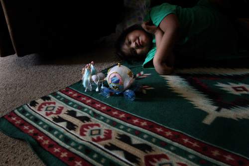 Djamila Grossman  |  Tribune file photo

LaRae Moon plays with her toy horses as she lays on a rug in the living room of her family's house in Ibapah, Utah on the Goshute Reservation, in 2011. This photo, by then-Salt Lake Tribune photographer Djamila Grossman, is one of the images included in "Through Her Eyes: Photography by Utah Female Journalists," an exhibit opening May 16, 2016, at the Salt Lake City Library's main branch.