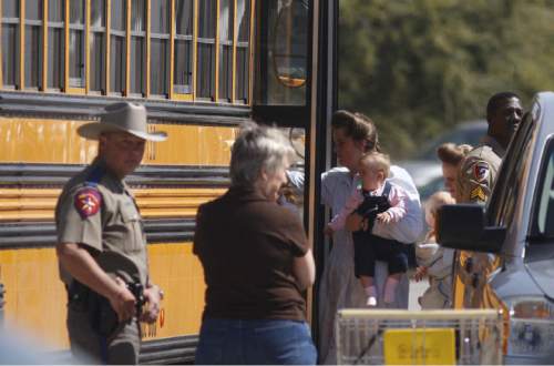 Trent Nelson  |  The Salt Lake Tribune

FLDS women and children from the YFZ Ranch are escorted by Texas Child Protective Services workers and Schleicher County Sheriff's deputies from the First Baptist Church's Fellowship Hall to waiting buses Sunday, April 6, 2008.