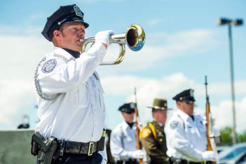 Chris Detrick  |  The Salt Lake Tribune
Officer John Clark plays 'Taps' on the bugle during the annual Memorial Service for fallen deputies and officers killed in the line of duty at the Salt Lake County Sheriff's Office Wednesday May 18, 2016.