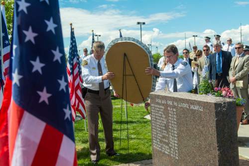 Chris Detrick  |  The Salt Lake Tribune
Sheriff James M. Winder and Sergeant Jeff Evans lay the wreath during the annual Memorial Service for fallen deputies and officers killed in the line of duty at the Salt Lake County Sheriff's Office Wednesday May 18, 2016.