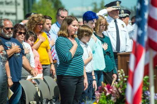 Chris Detrick  |  The Salt Lake Tribune
Erika, Jack, Matti and Merri Barney listen as Sergeant David Glad performs 'Amazing Grace' on the bagpipes during the annual Memorial Service for fallen deputies and officers killed in the line of duty at the Salt Lake County Sheriff's Office Wednesday May 18, 2016. Unified Police Officer Douglas S. Barney was murdered January 17, 2016 while investigating a hit and run crash in Holladay.