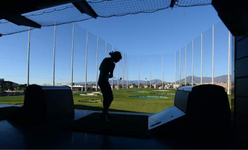 Steve Griffin | The Salt Lake Tribune

Golfers get their first swing at TopGolf in Midvale. The venue includes food and drinks and is a way for couples and groups to enjoy a night out, even if they don't play golf.