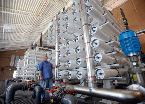 Al Hartmann |  The Salt Lake Tribune
Lead operator Mike Axelgard works on Jordan Valley Water Conservancy District's reverse osmosis Southwest Groundwater Treatment Plant Wednesday May 13, 2015. It's reaching its final phase to clean up a plume contaminated by historic mining activities at Bingham Canyon. The Southwest Groundwater Treatment Plant uses reverse osmosis to produce 4,500 acre feet of clean drinking water a year. Now the district is seeking final permission to pipe 1.5 million gallons of selenium-laced byproduct water in the Great Salt Lake.