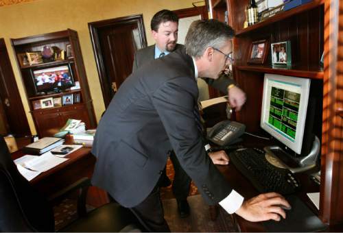 Tribune file photo
Then-Utah Gov.  Jon Huntsman, right, checks on the progress of legislative bills with Neil Ashdown, left, his chief of staff, in this 2008 photo. Ashdown was a top aide to Huntsman when he went to Beijing as U.S. ambassador to China. Ashdown then worked on the Huntsman presidential campaign, and later for Zions Bank, Sen. Mike Lee and, most recently, Rocky Mountain Power..