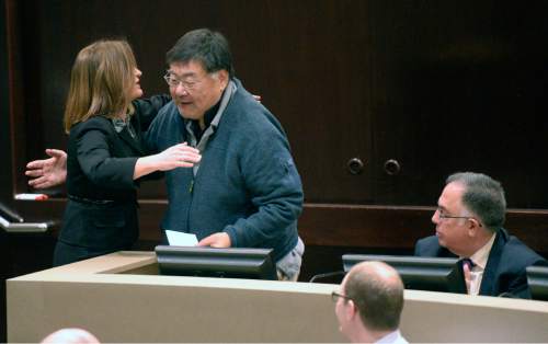 Al Hartmann  |  Tribune File Photo

Incoming Salt Lake County Council member Jenny Wilson, left, gives a hug to friend and mentor councilman Randy Horiuchi at his last meeting Monday January 5, 2015.