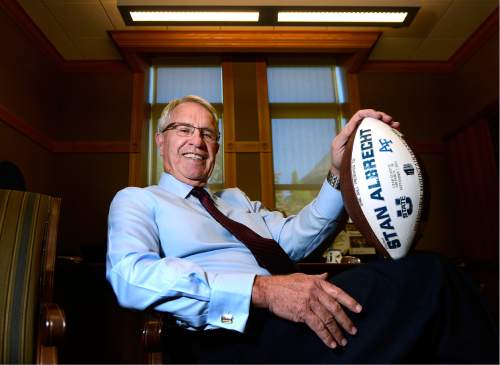 Scott Sommerdorf   |  The Salt Lake Tribune  
USU President Stan Albrecht poses with a commemorative football from USU's 52-20 victory over Air Force in the University's inaugural Mountain West game in 2013. He is retiring from his position with the University, Wednesday, May 18, 2016.