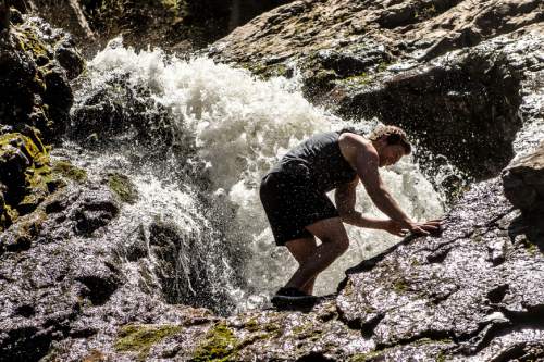 Trent Nelson  |  The Salt Lake Tribune
Scott Long cools off in the water at Donut Falls in Big Cottonwood Canyon, Tuesday May 27, 2014.