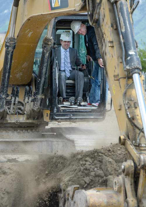 Francisco Kjolseth | The Salt Lake Tribune
South Jordan City mayor David Alvord, left,  gets in on the fun for the ground breaking ceremonies of tech company InMoment as CEO and founder John Sperry passes along what he's learned. Said to be a first-of-its-kind urban transit oriented development in South Jordan will be directly adjacent to the FrontRunner line.