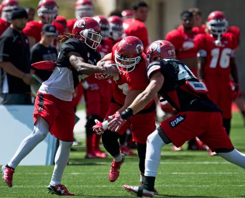 Lennie Mahler  |  The Salt Lake Tribune

Tight end Evan Moeai gains some yards on a pass as Justin Thomas looks to stop him during Utah football fall camp at Rice-Eccles Stadium in Salt Lake City.  Saturday, Aug. 8, 2015.