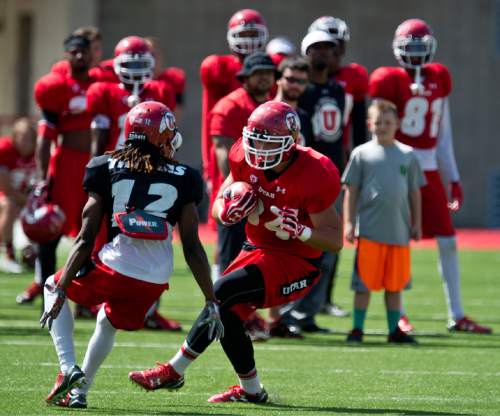 Lennie Mahler  |  The Salt Lake Tribune

Tight end Evan Moeai gains some yards on a pass as Justin Thomas looks to stop him during Utah football fall camp at Rice-Eccles Stadium in Salt Lake City.  Saturday, Aug. 8, 2015.
