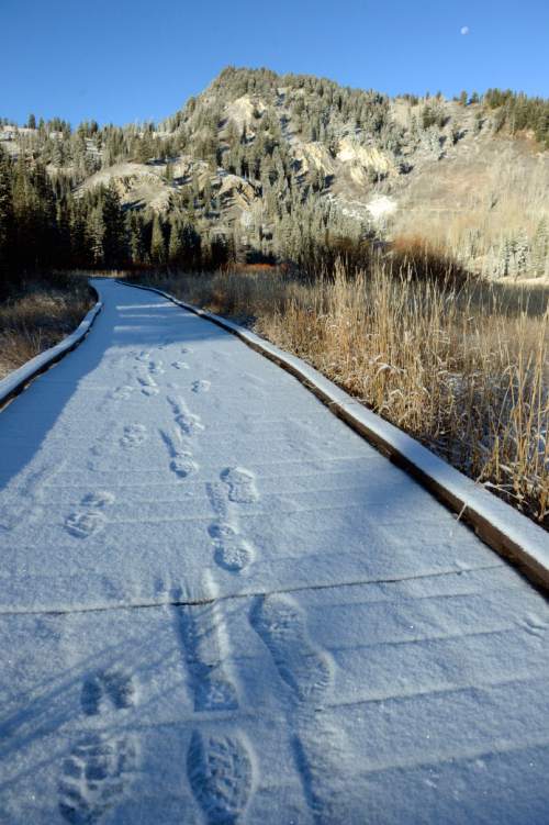 Al Hartmann  |  The Salt Lake Tribune
First skiff of snow dusted the high country and peaks in Big Cottonwood Canyon Friday Oct. 30.  Fresh footprints mark the path of early morning hikers on the boardwalk of Silver Lake.
