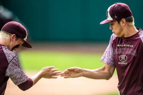 Chris Detrick  |  The Salt Lake Tribune
Maple Mountain's Jeff Mack (8), right, and Jarrett McAllister practice their extended handshake routine during the 4A quarterfinal baseball game against Orem at Utah Valley University Tuesday May 24, 2016.