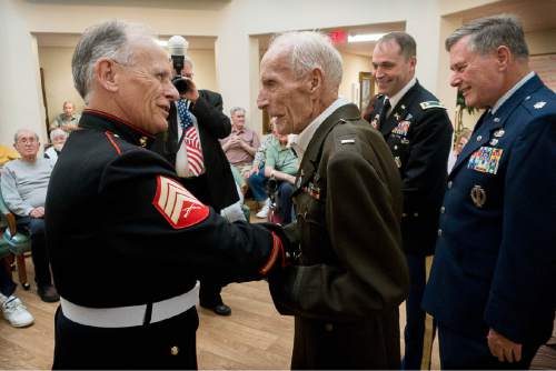 Trent Nelson  |  The Salt Lake Tribune
1st Lieutenant Dan M. Eastman (a 96 year old veteran of WWII) shakes hands with Marine Sergeant Dennis Howland after receiving the Honor Salute at the Olympus Ranch Retirement Community in Murray, Wednesday May 25, 2016. At right are Lieutenant Colonel Matt Harmon and Lieutenant Colonel Robert King (retired, far right).