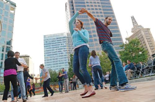 Leah Hogsten  |  The Salt Lake Tribune
Faith Denzer and Daniel Howland, students at the University of Utah, swing dance. Dancers twirl around the parquet flooring to the Big Band Summer event at Gallivan Center, Tuesday, May 24, 2016 with City Jazz Big Band and singer, Katrina Cannon. The event is the first in a series of 17 Tuesday night dances. Along with City Jazz Big Band,  other bands such as Wasatch Jazz Project, Caleb Chapman's Crescent Super Band, and Tad Calcara & New Deal Swing (to name a few) will be featured. The Gallivan Center sets up a large outdoor dance floor. All these events are free.