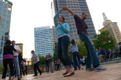 Leah Hogsten  |  The Salt Lake Tribune
Faith Denzer and Daniel Howland, students at the University of Utah, swing dance. Dancers twirl around the parquet flooring to the Big Band Summer event at Gallivan Center, Tuesday, May 24, 2016 with City Jazz Big Band and singer, Katrina Cannon. The event is the first in a series of 17 Tuesday night dances. Along with City Jazz Big Band,  other bands such as Wasatch Jazz Project, Caleb Chapman's Crescent Super Band, and Tad Calcara & New Deal Swing (to name a few) will be featured. The Gallivan Center sets up a large outdoor dance floor. All these events are free.