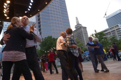 Leah Hogsten  |  The Salt Lake Tribune
Dancers twirl around the parquet flooring to the Big Band Summer event at Gallivan Center, Tuesday, May 24, 2016 with City Jazz Big Band and singer, Katrina Cannon. The event is the first in a series of 17 Tuesday night dances. Along with City Jazz Big Band,  other bands such as Wasatch Jazz Project, Caleb Chapman's Crescent Super Band, and Tad Calcara & New Deal Swing (to name a few) will be featured. The Gallivan Center sets up a large outdoor dance floor. All these events are free.