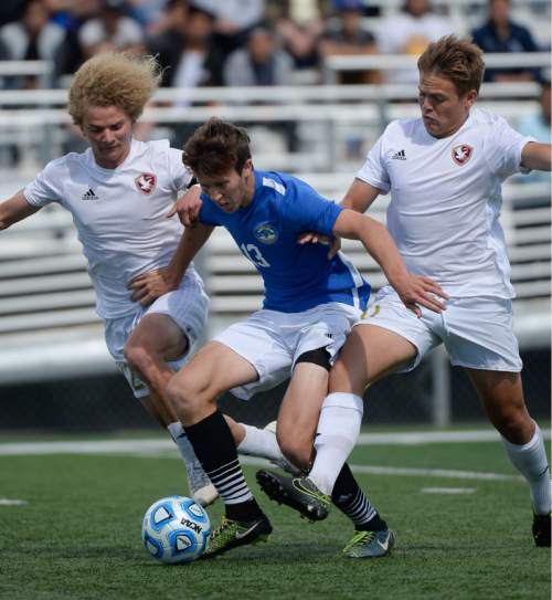Francisco Kjolseth | The Salt Lake Tribune
Orem's Zachary Wells gets sandwiched between the Maple Mountain defense as they battle it out in Draper for the Class 4A boys' soccer championship.