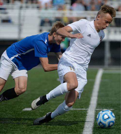 Francisco Kjolseth | The Salt Lake Tribune
Maple Mountain's Ian Stonehocker, right, pushes past Orem in game action in Draper for the Class 4A boys' soccer championship.