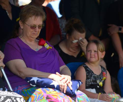 Leah Hogsten  |  The Salt Lake Tribune
Oakley Ricks looks at her grandmother Lorie Ricks who sits at her husband's graveside, Utah Transit Authority electrician Kay Ricks, 63, who was laid to rest Saturday, May 28 at Lehi City Cemetery. Ricks served in the Navy and was a veteran of the Vietnam War, 4 years active duty and 2 years in the Naval Reserve and 8 years in the Utah National Guard. Utah police continue gathering evidence that could link two men who fled to Wyoming, after tying up and assaulting a mother and her four teenage daughters in a Centerville home on May 10, to the slaying of Ricks employee whose body was found in rural Wyoming.