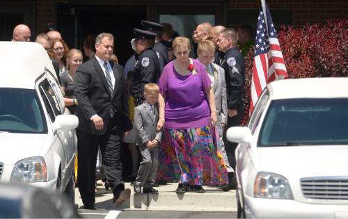 Leah Hogsten  |  The Salt Lake Tribune
Lorie Ricks leaves the American Fork West Stake with her family after the funeral for her husband, Utah Transit Authority electrician Kay Ricks, 63, Saturday, May 28, 2016. Utah police continue gathering evidence that could link two men who fled to Wyoming, after tying up and assaulting a mother and her four teenage daughters in a Centerville home on May 10, to the slaying of Ricks employee whose body was found in rural Wyoming.
